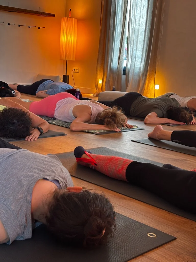 Students in a resting pose during a yoga session