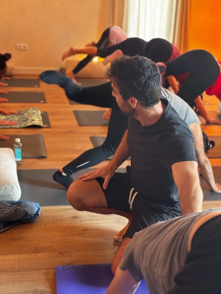 Yoga teacher supervising a class in the studio