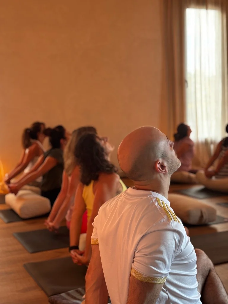 Group seated chest-opening stretch in yoga class